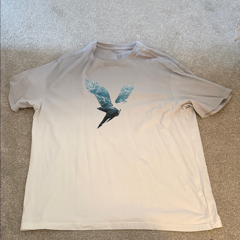 American Eagle Outfitters Cream T-Shirt with Blue Bird Design